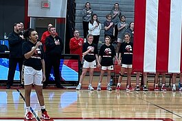 Caylin McCormick sings the national anthem in the Huron gym.