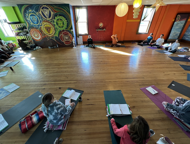 Members of the Yoga Instructor Program listen to Brian Henderson during a November training session.