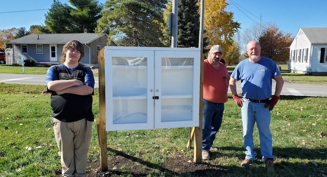 Kyle Werner stands with a Blessing Box and two of his scout leaders, Dale Borzon and Eric Wehner.