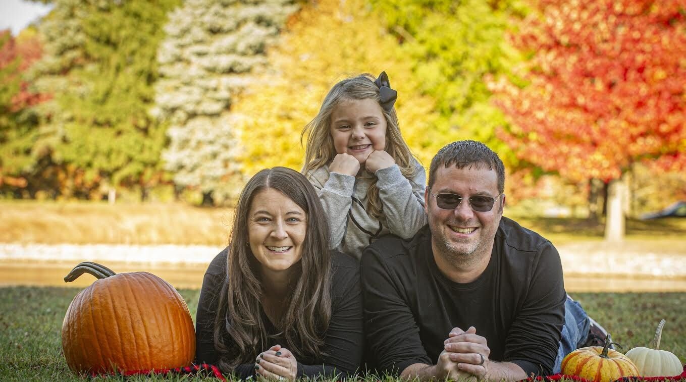 Author Julie Didion Wambold, daughter Madison, and husband Mike, whose name helped to inspire the raccoon character's name.