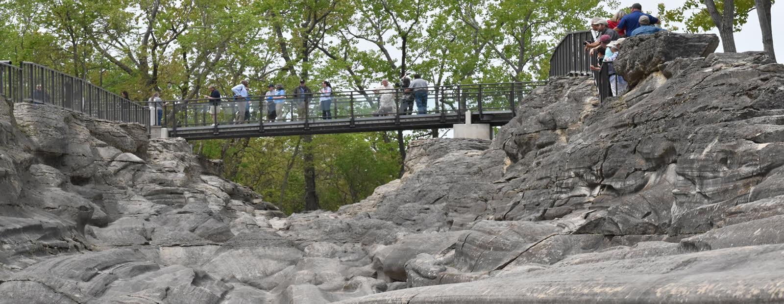 Visitors gather for the Glacial Grooves rededication ceremony May 19.