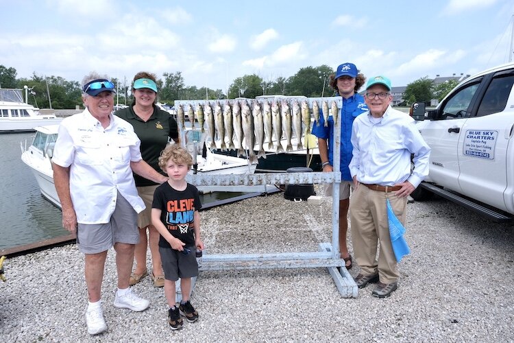 (From left) Captain Peg VanVleet; Division of Wildlife Chief Kendra Wecker; the governor's 5-year-old grandson, Desi; and Gov. Mike DeWine fished on VanVleet's boat. 