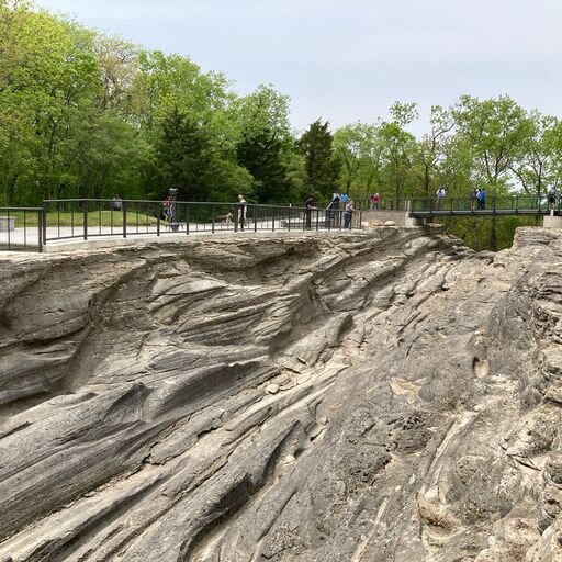 Visitors gather for the Glacial Grooves rededication ceremony May 19.