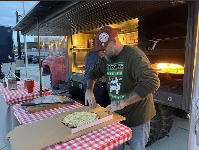 Jeremey prepares a pizza for a customer during Winter Wonderland in downtown Sandusky.