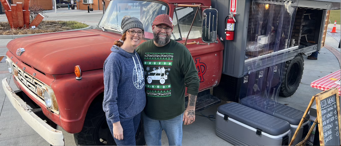Mallie and Jeremey Adams pose in front of the renovated 1964 Ford that serves as their mobile pizza business, Archie's Pizza.