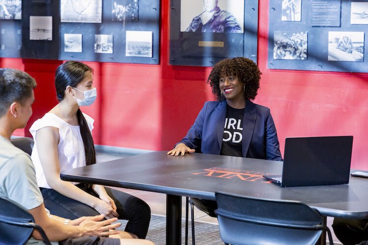 Girls Who Code CEO Tarika Barrett talks with students