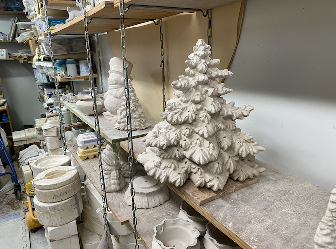 A Christmas tree newly removed from its mold sits in Deal's basement.