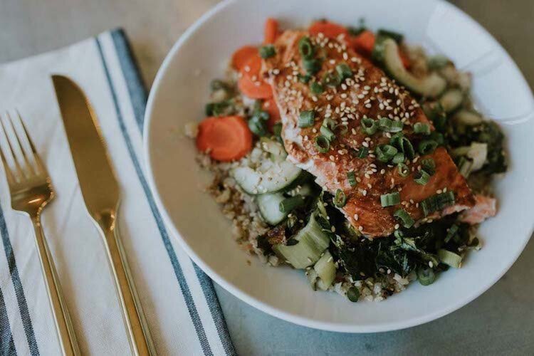 One of Dena Fisher's creations: a salmon bowl with wild rice, pickled carrot, bok choy and sesame vinaigrette.