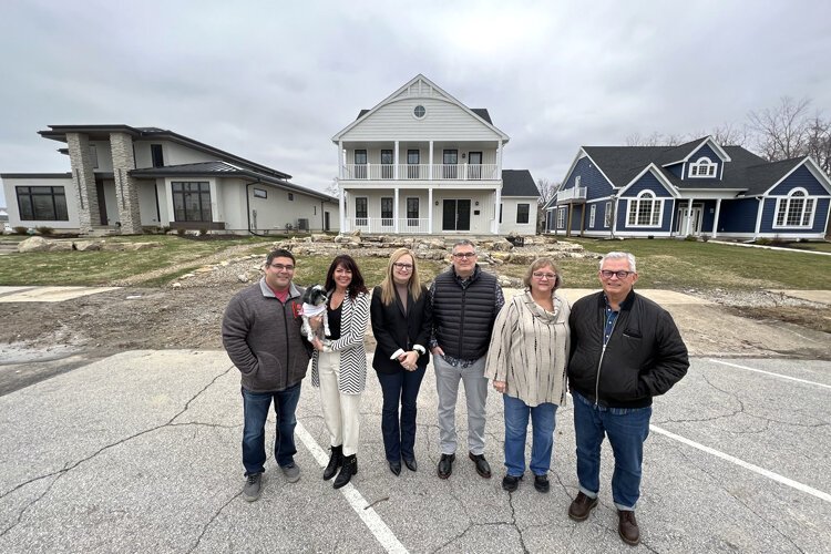 The Torres, Parthemores and Colliers outside of their Market Street homes.