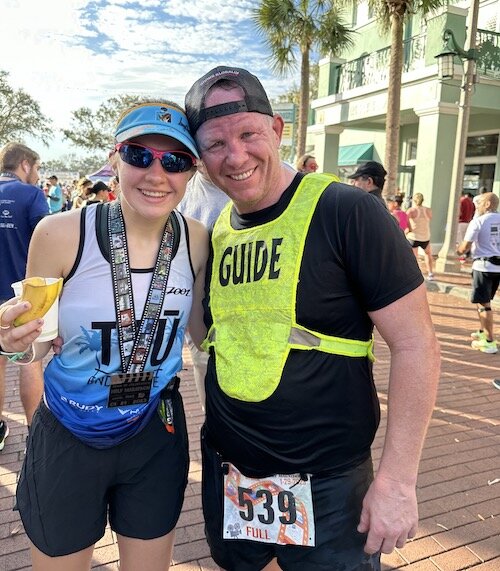 Dan and Adrienne pose for a picture after the Celebration Half Marathon.