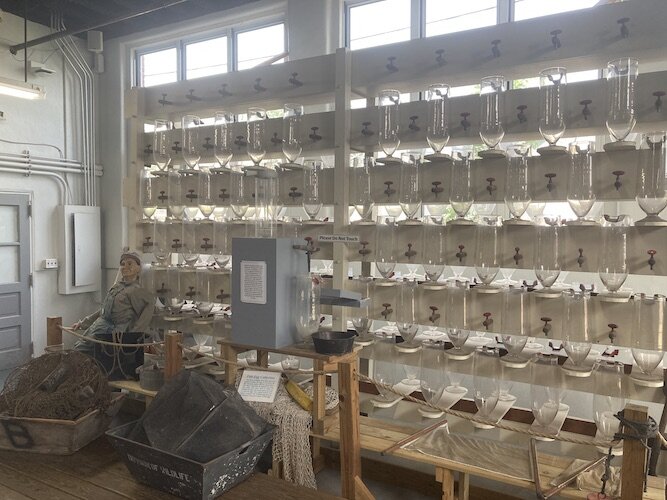 Fish hatchery equipment lines the walls of the Aquatic Center.