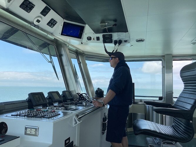 Captain Brian Woischke drives the "Mary Ann Market" from Put-in-Bay to the mainland. 