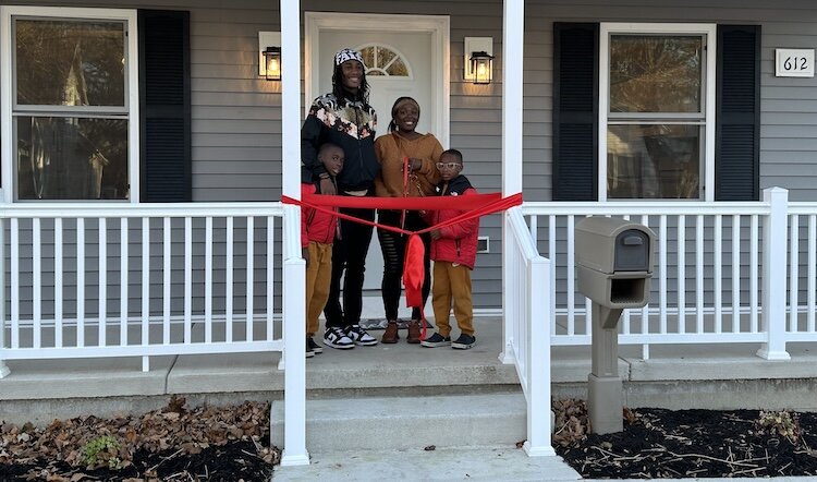 The residents of the most recently completed Habitat home on Neil Street in Sandusky attended the home's dedication ceremony.