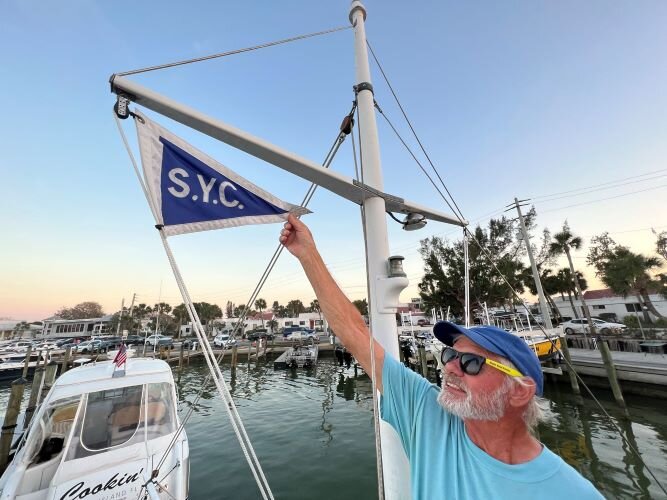 Richie Brown shows off his Sandusky Yacht Club flag aboard the Tina B.