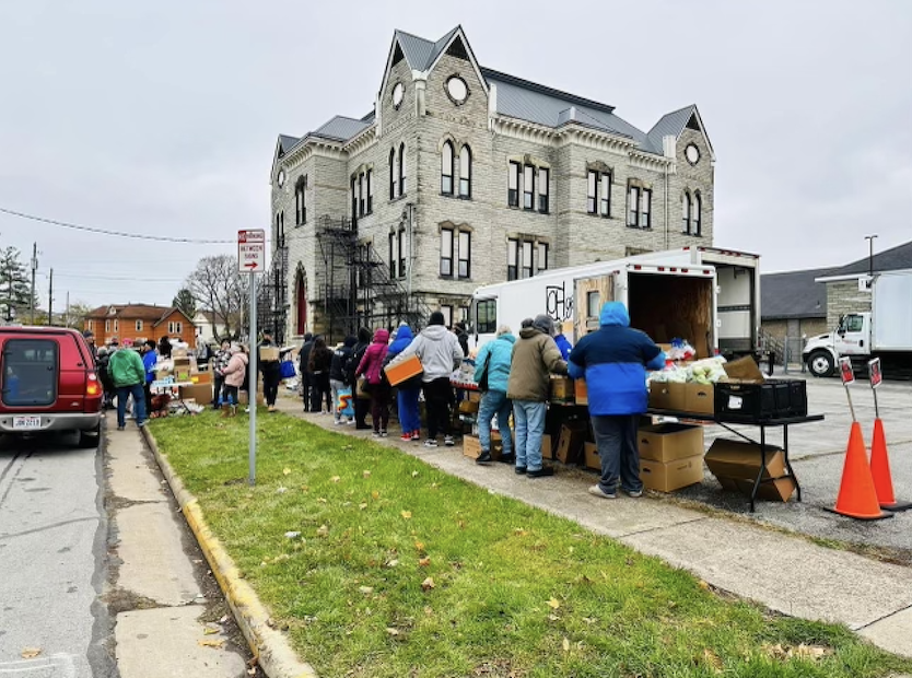 OHgo organizes and oversees the distribution of food items at the Nehemiah Partners Center.