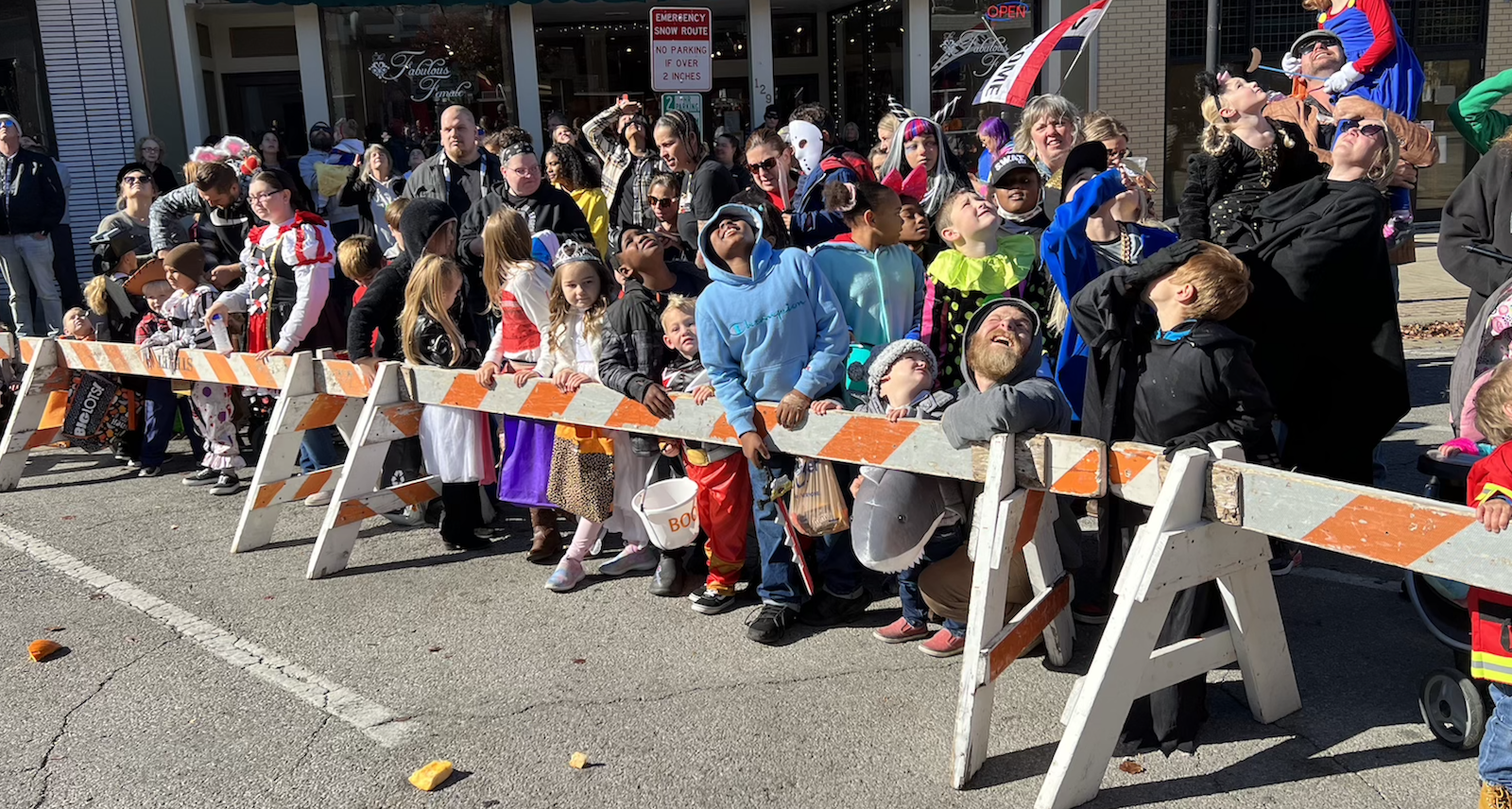 Event goers watch as pumpkins are dropped on Columbus Avenue during the Annual Downtown Trick or Treat in 2022.