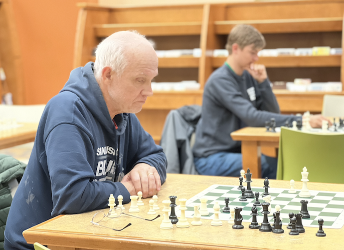 Sherwood teaches an opponent during a "Chess with Paul Sherwood" session at the Huron Library.