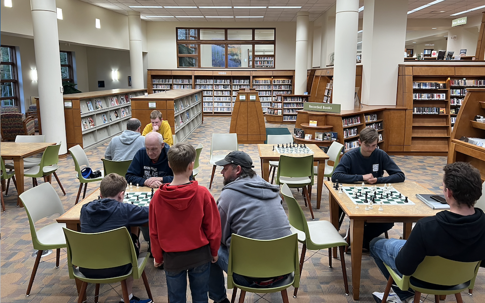 Players attend a "Chess with Paul Sherwood" evening at the Huron Library.
