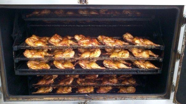 Chicken cooks on the pit at Snooties BBQ.